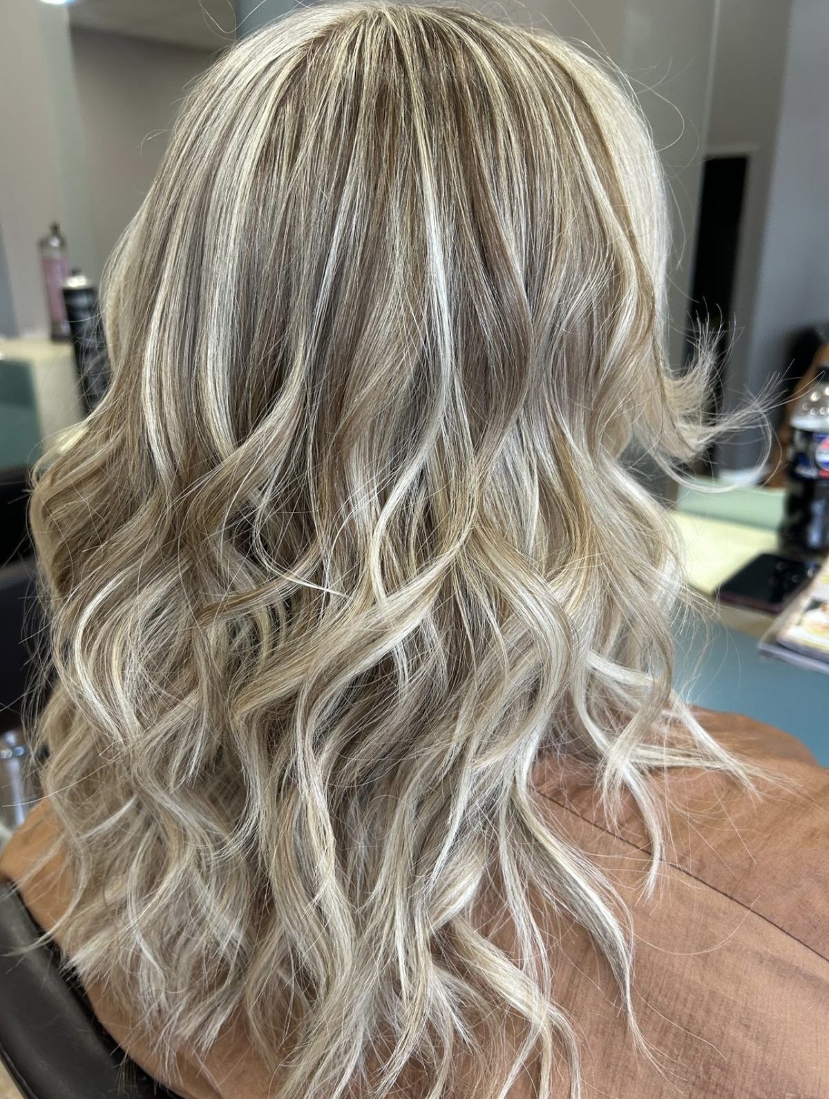 Long hair with cool blonde highlights, finished in soft waves